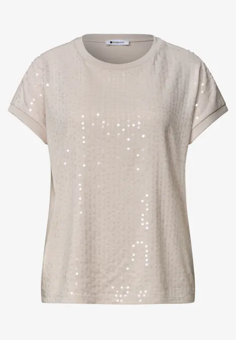 T-shirt beige à manches courtes orné de sequins, col rond et coupe décontractée.