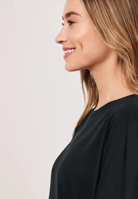 Profielfoto van een glimlachende vrouw met blond haar en zwart shirt tegen een lichte achtergrond.