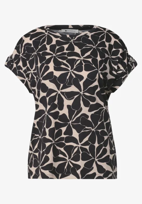 Beiges Shirt mit lockerem Schnitt und schwarzem Blumenmuster.