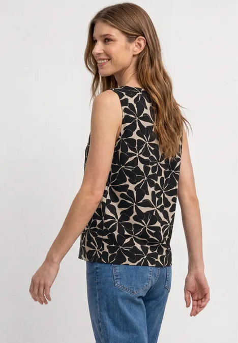 Top mit Rundhals und Schulterdetail Black Frau von hinten in blauer Jeans und schwarzem, ärmellosem Top mit weißem, geometrischem Sternmuster.