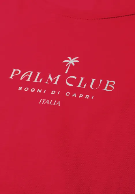 Rood T-shirt met wit „Palm Club“-logo, palmboom-icoon en tekst „Sogni di Capri Italia“.