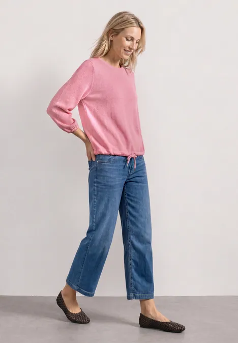 3/4-Arm Shirt mit Rundhals im Strick-Look blush berry mel. Frau in pinkem Pullover, blauen Jeans und schwarzen Ballerinas steht seitlich an einer Wand.