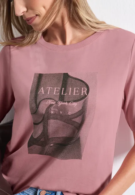 Shirt met ronde hals en fotoprint vintage blush Frau in rosafarbenem T-Shirt mit Schriftzug 'ATELIER' und grafischem Schwarz-Weiß-Motiv.