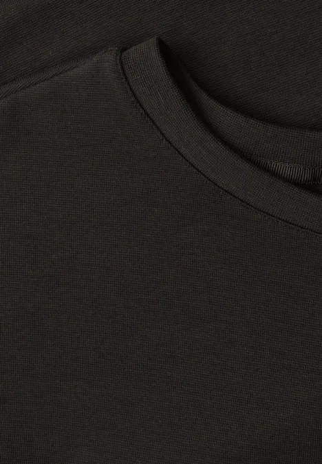 Nahaufnahme eines schwarzen T-Shirts mit Rundhalsausschnitt und glatter Textur.