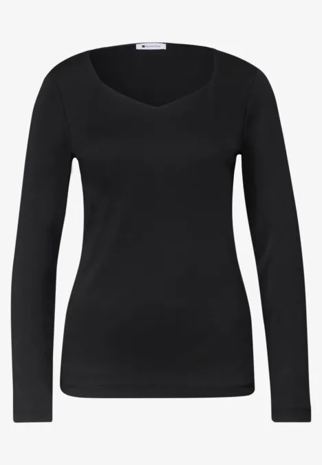 Top à manches longues noir avec encolure arrondie et coupe ajustée.