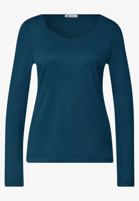 Dameslangarmshirt in petrolblauw met ronde hals en slanke pasvorm.