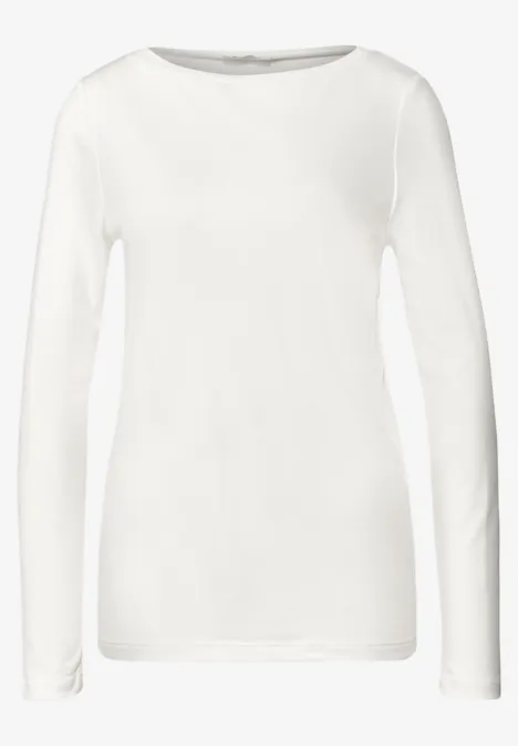 Ein schlichtes, weißes Langarmshirt mit Rundhalsausschnitt und schmaler, körpernaher Passform.
