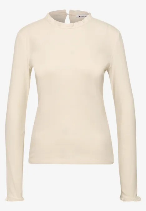 Beige shirt met lange mouwen, ronde hals en smalle pasvorm.