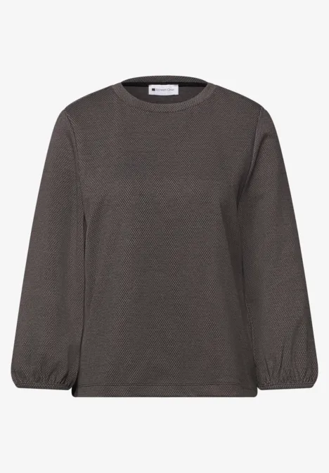 Ein graues Langarmshirt mit Rundhalsausschnitt und elastischen Bündchen.