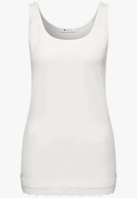 Haut long à col rond et dentelle à l'ourlet off white Weißes ärmelloses Top mit Rundhalsausschnitt und zarter Spitzenverzierung am Saum.
