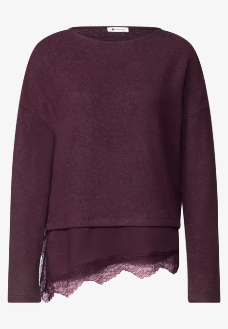 Lila Pullover mit langen Ärmeln, asymmetrischem Lagen-Look und zarter Spitzenverzierung am Saum.