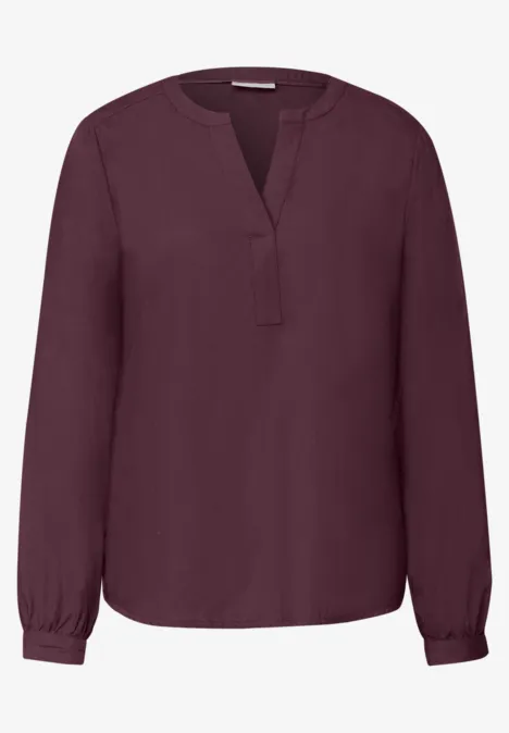 Tuniek met V-hals rustic rouge Dunkelrote, locker geschnittene Damenbluse mit V-Ausschnitt, langen Ärmeln und schmalen Manschetten.