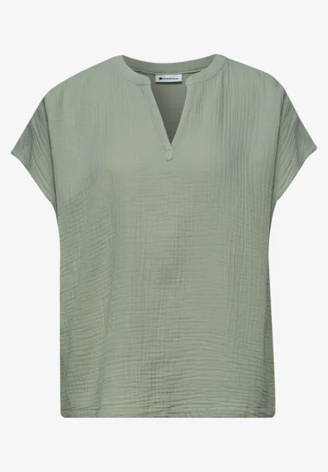 Saliegroen T-shirt met korte mouwen, V-hals en fijne textuur.