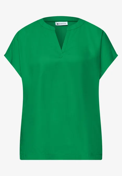 Ein schlichtes, grünes, kurzärmeliges Damenoberteil mit V-Ausschnitt.