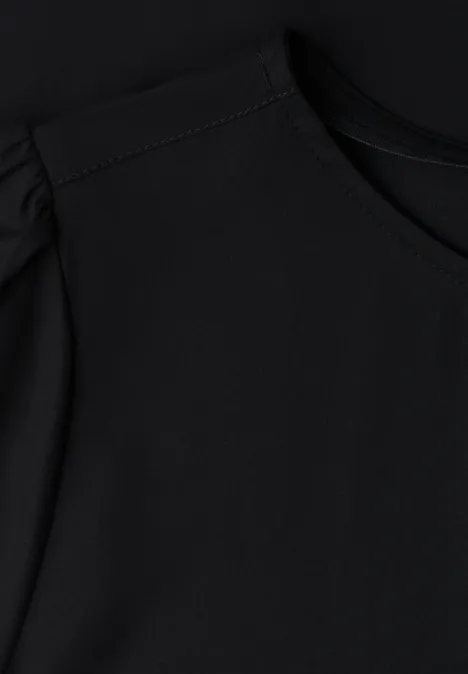 Blouse met ronde hals en korte pofmouwen Black Zwart shirt met ronde hals en subtiele pofmouwtjes