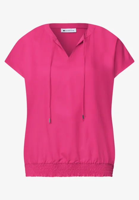 Rosa Bluse mit kurzen Ärmeln, V-Ausschnitt mit Kordelzug und elastischem Saum.