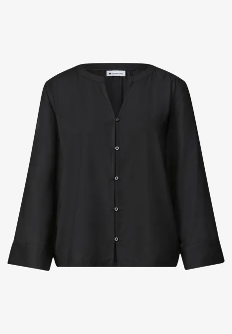 Schwarze Bluse mit langen Ärmeln, V-Ausschnitt und Knopfleiste.