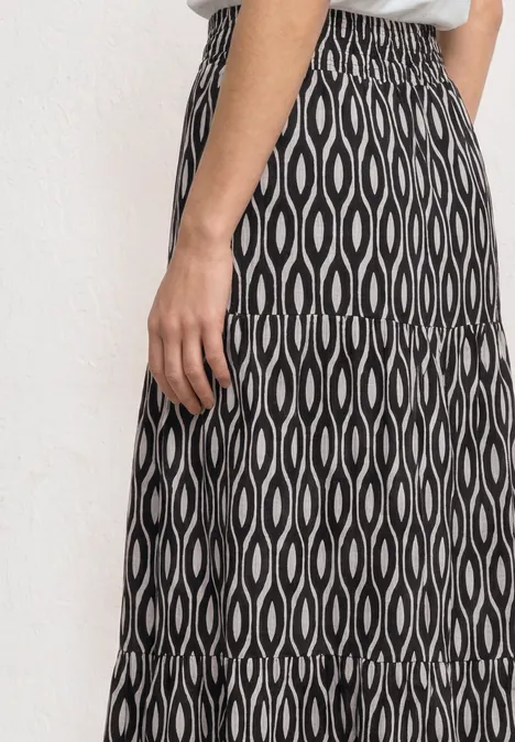 Maxi-Rock mit Volants und Print clay sand Schwarz-weißer Midirock mit wellenförmigem Ovalmuster und elastischem Bund.