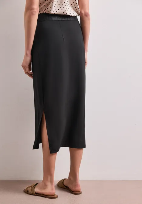Midirok van tricot in effen kleur Black Zwarte midirok met zijsplit, gecombineerd met sandalen.