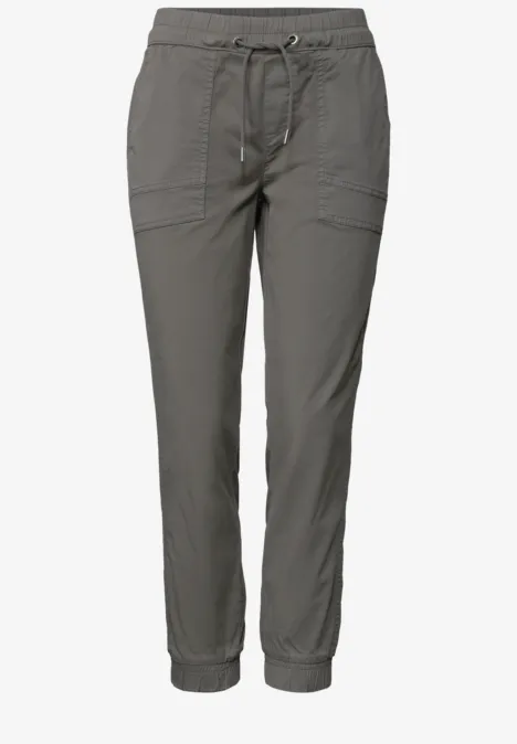 Pantalon femme décontracté gris avec cordon de serrage, poches plaquées et bas élastiques.