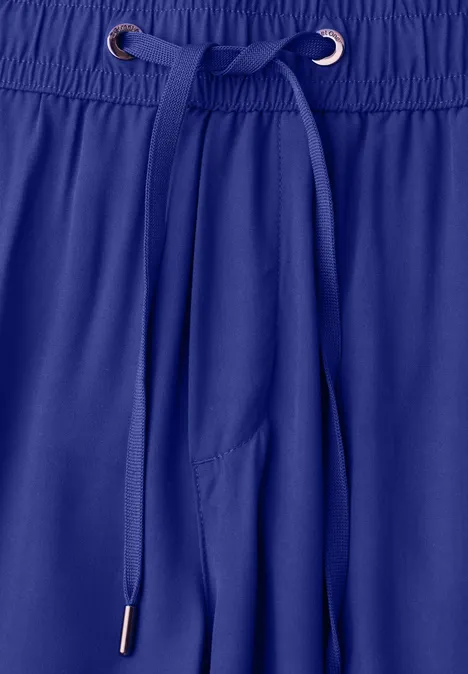 Blauwe sportbroek met trekkoord aan de elastische tailleband.