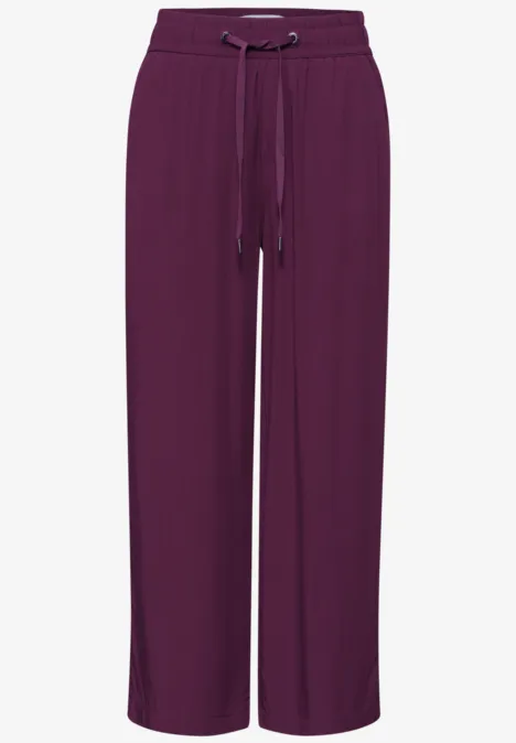 Losse bordeauxrode damesbroek met wijde pijpen en trekkoord in de taille voor comfort.
