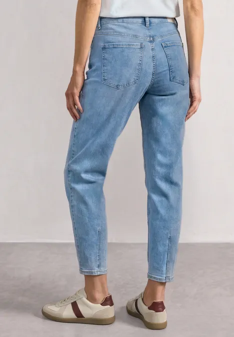 High Waist Barrel Leg Jeans im Loose Fit Light Blue Wash Rückenansicht einer Person in hellblauen, hochgeschnittenen Jeans und beigen Sneakern mit braunen Details.