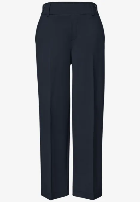 Pantalon de costume bleu foncé, coupe droite avec plis marqués.