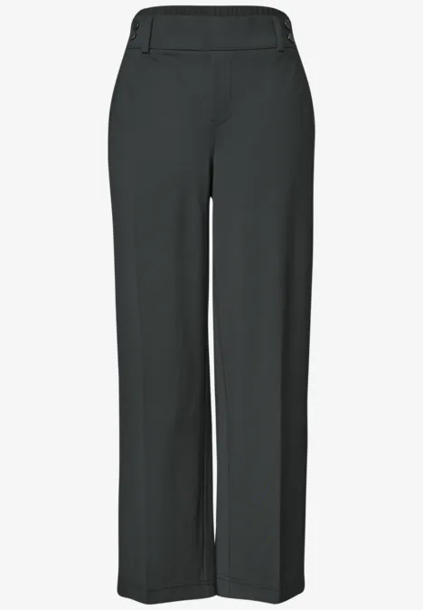 Pantalon noir sobre, taille élastique et coupe droite.