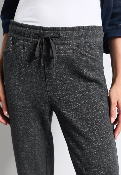 Graue Jogginghose mit Kordelzug und seitlichen Taschen an einer Person