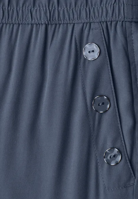 Pantalon bleu foncé en tissu avec taille élastique et trois boutons latéraux
