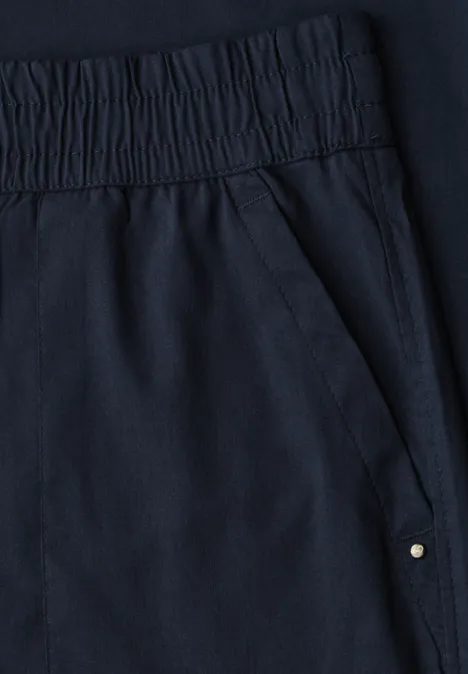 Donkerblauwe broek met elastische taille en zijzak met metalen klinknagel.