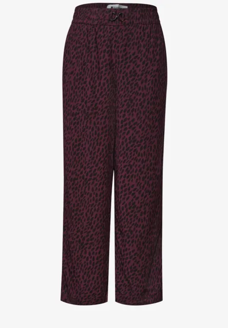 Locker geschnittene weinrote Hose mit schwarzem Leoprint und elastischem Bund.