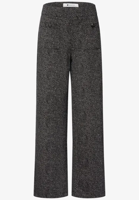 Weite, hoch taillierte Damenhose aus dunklem Tweed mit seitlichen Taschen.