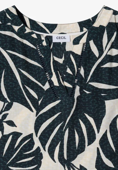 Robe mi-longue à col fendu et imprimé palm breeze green Top noir à motif de grandes feuilles de monstera blanches et encolure fendue discrète.
