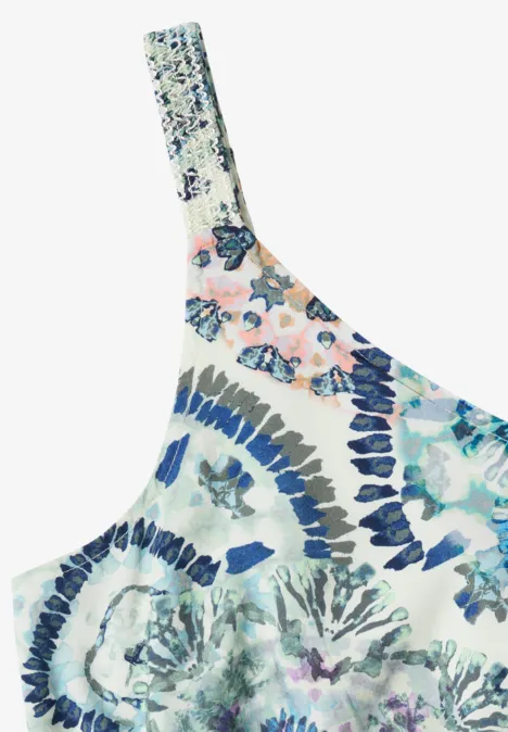 Ein einseitiges Oberteil mit bunter, floraler Musterung in Blau- und Rosatönen.