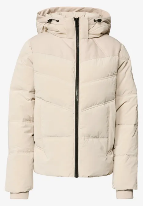 Leichte beige Steppjacke mit Kapuze, durchgehender Reißverschluss und gerippten Ärmelbündchen.