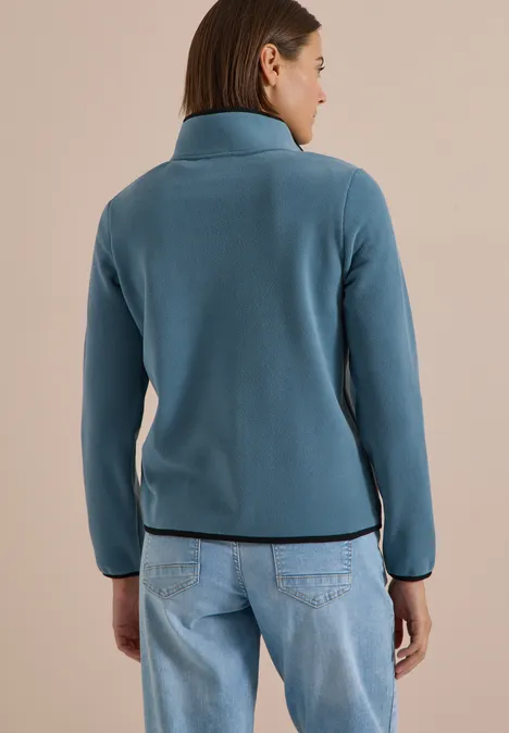 Fleecejacke mit Zipper und Stehkragen mountain air blue Rückansicht einer Frau in türkiser Jacke und Jeans.