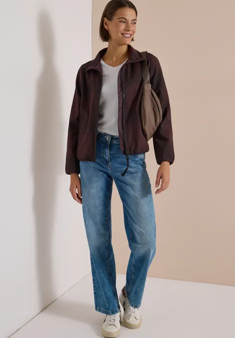 Karierte Jacke in Wolloptik mit Stehkragen red wine melange Frau im lässigen Outfit: Jeans, T-Shirt, Jacke, weiße Sneaker, lächelnd mit Tasche über der Schulter.