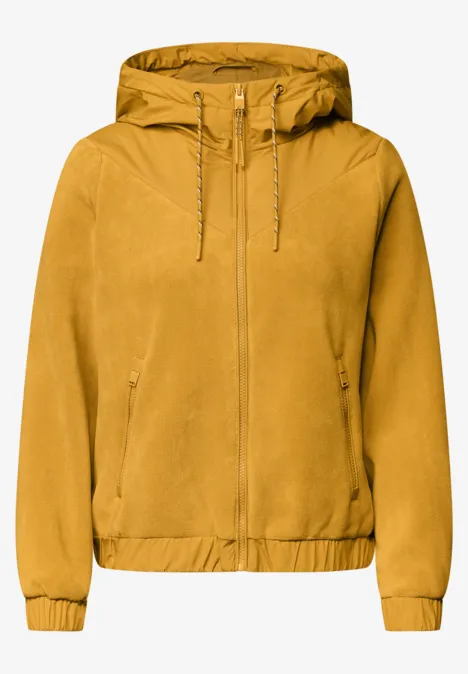 Fleecejas met capuchon en softshell-details golden honey Senfgelbe Kapuzenjacke mit Reißverschluss, Kordelzug an der Kapuze, Taschen und elastischem Bund.