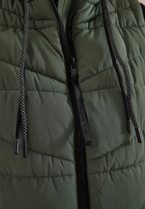 Lange Steppweste mit Stehkragen shadow khaki Naheaufnahme einer dunkelgrünen Steppjacke mit schwarzem Reißverschluss und Kordelzügen.