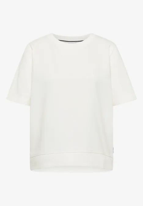 Sweater met korte mouwen en ronde hals vanilla white Een eenvoudig wit T-shirt met korte mouwen tegen een witte achtergrond.