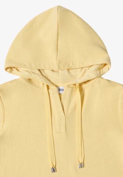 Hellgelber Kapuzenpullover mit feiner Waffelstruktur.