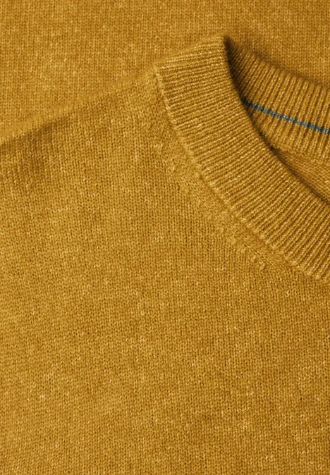 Nahaufnahme eines senfgelben Strickpullovers mit Rundhalsausschnitt und feiner Maserung.
