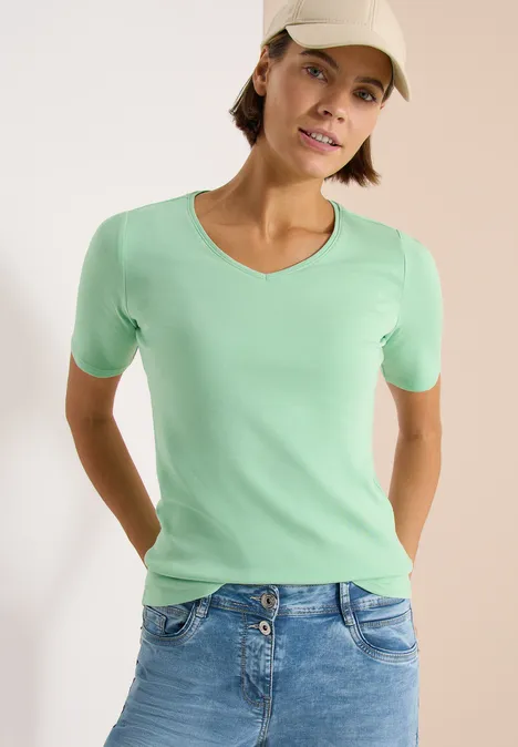 Basic katoenen shirt juicy lime Vrouw in mintgroen T-shirt en spijkerbroek, casual houding
