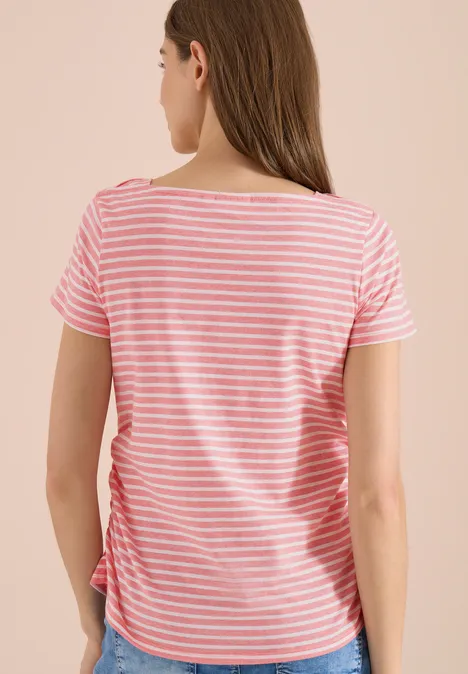 Rückansicht einer Frau in rosa-weiß gestreiftem T-Shirt vor hellem Hintergrund.