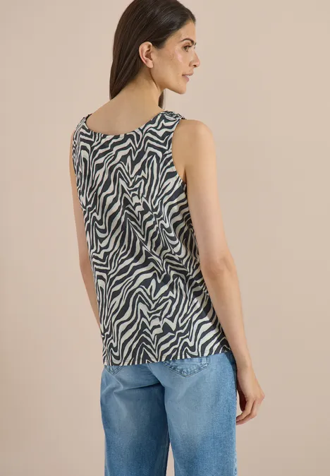 Top met ronde hals en plooidetails palm breeze green Achteraanzicht van een vrouw in een blauwe spijkerbroek en mouwloos topje met zebraprint.