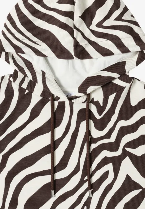 Wit-bruine capuchontrui met zebraprint.