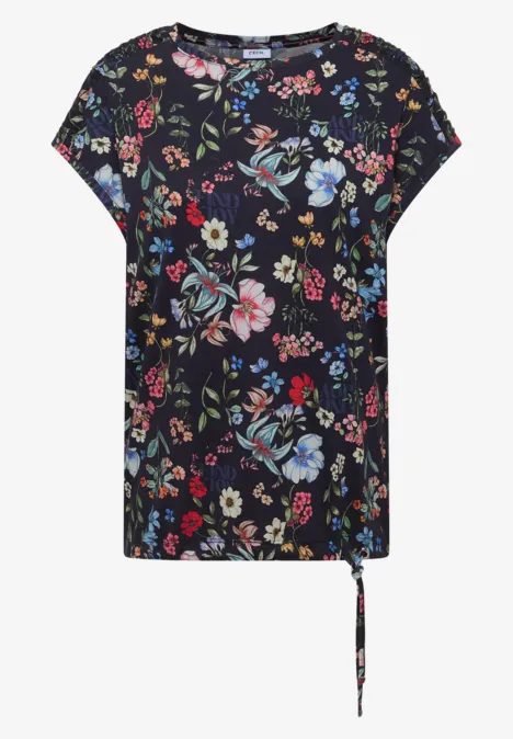 Schwarzes kurzärmeliges Shirt mit buntem floralen Muster und lockerem Schnitt.