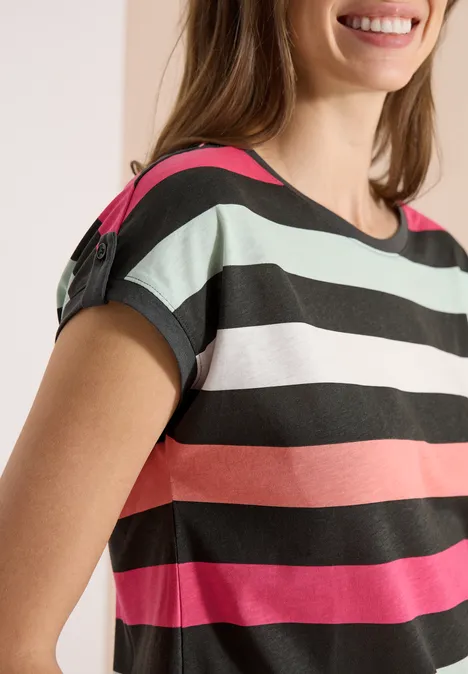 Frau in kurzärmligem Shirt mit bunten horizontalen Streifen in Schwarz, Weiß, Mintgrün, Koralle und Pink.